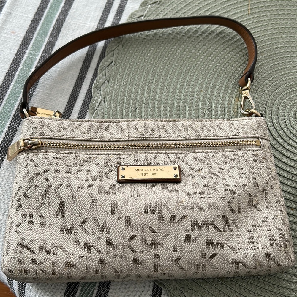 Small Michael Kors cream colored clutch.